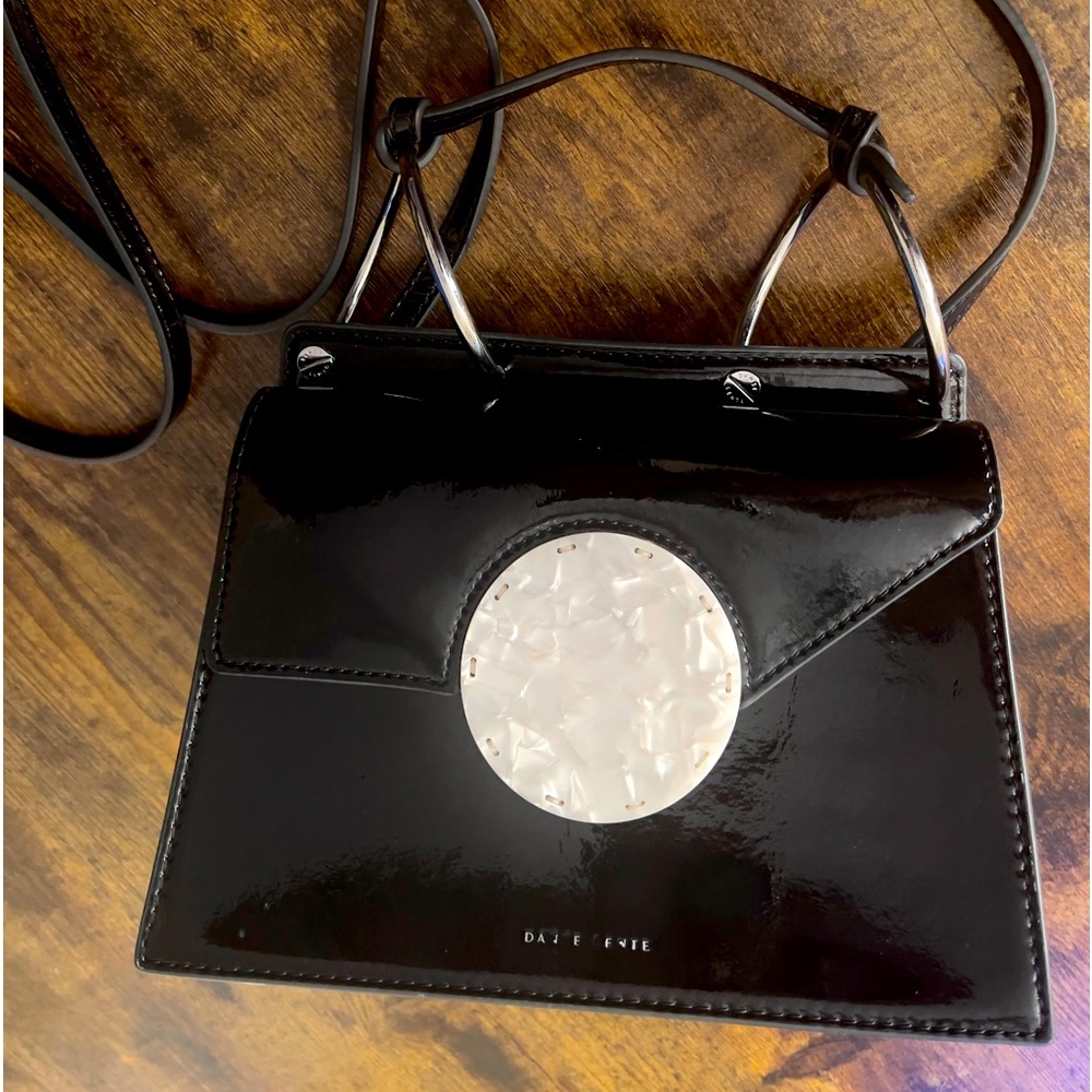 Danse Lente cross body structured black patent leather purse. Used once with tag